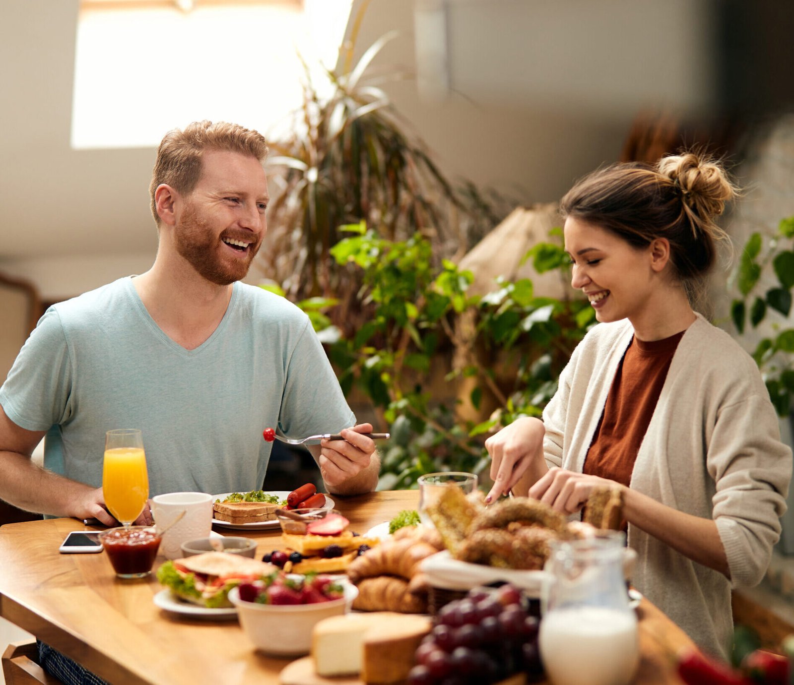 happy couple enjoying conversation while eating dining table scaled e1708700949204